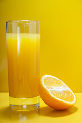 Оrange juice on a yellow background