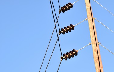 Power line with glass insulators and wires. One power pole off center, room for copy.  Blue sky in...