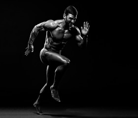 Muscular Men in Running Motion. Handsome Male Athlete Sprinting