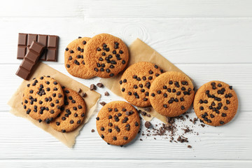 Composition with chip cookies and chocolate on white wooden background