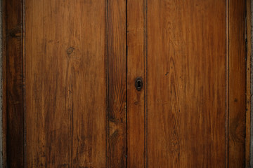 Simple wooden wardrobe door with a keyhole.