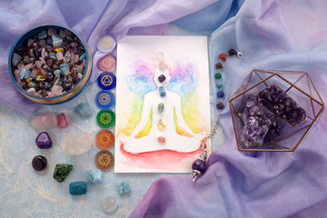 Natural crystals and pendulum on pastel silk background. Reiki background with card. - obrazy, fototapety, plakaty