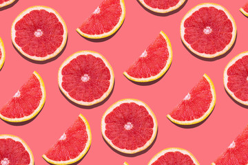 Fresh red orange or grapefruit on a peach color background.