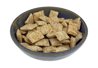 Generic shredded wheat cereal in a stoneware bowl
