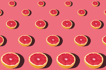 Fresh red orange or grapefruit on a peach color background.