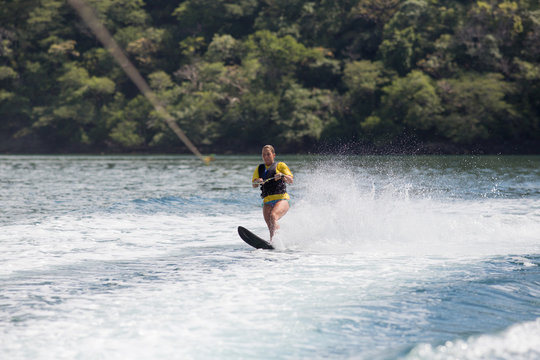 Female wake boarding in Costa Rica.