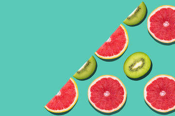 Seamless pattern with juicy kiwi and greapfruit on light blue background