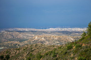 Fototapeta premium A wind farm is located along a picturesque valley.