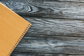 top view of notebook on dark wooden surface with copy space