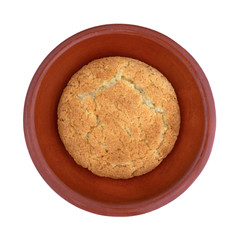 Single coconut flavor cookie on a small dish