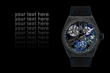 Beautiful men's wrist watch. transparent dial. isolated on black background. closeup With copyspace