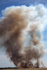 Strong prairie fire with large clouds of choking smoke erupted in southern steppe during the summer drought. The line of fire is coming to town houses. Ecological catastrophy