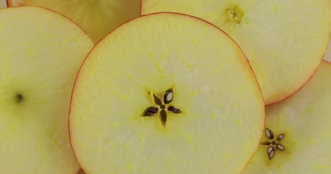Fresh apple slices. The apple sliced ​​into pieces is rotated for 4 shots. Organic, red, sliced, vegetarian.