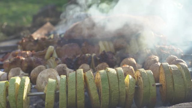 guys cook food on a fire, vegetables and meat are fried on a fire, zucchini and onions, peppers and beef, pita bread, cook kebab