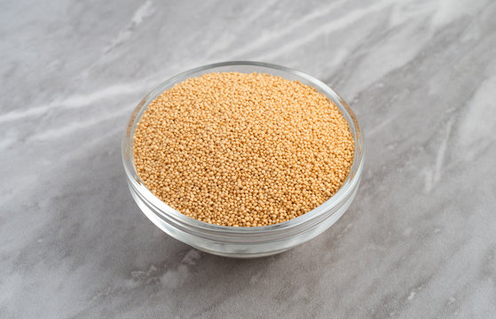 Bowl Of Organic Amaranth Seeds On A Marble Countertop Side View