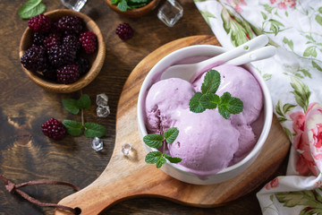 Homemade Organic Ice Cream with Mint. Blackberry ice cream in white bowl on a rustic table. Copy space.