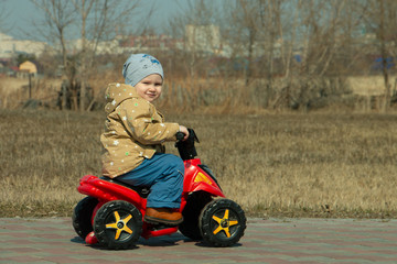 little boy on an electric Quad bike in the Park