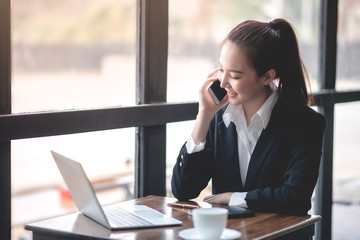 Businessmen are discussing business via phones and laptops.