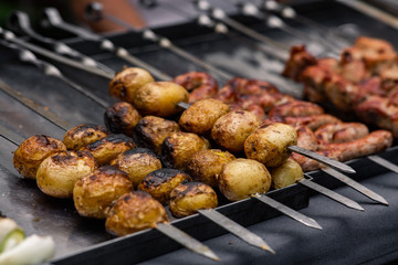 charcoal fried potatoes on skewers