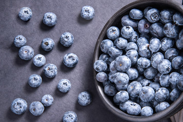 Fresh blueberries in black ceramic bowl