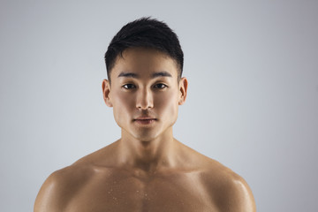 Muscular Asian Man Indoors in th Studio