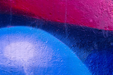 Beautiful bright colorful street art graffiti background. Abstract creative spray drawing fashion colors on the walls of the city. Urban Culture, pink , red , orange , yellow, crimson, blue texture