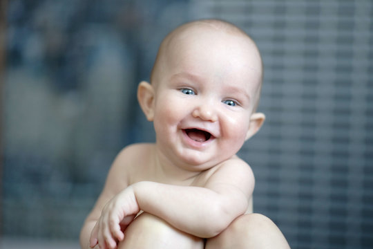 Closeup cute portrait of lttle cheerful laughing. Happy child leaning on mothers. Love, tenderness