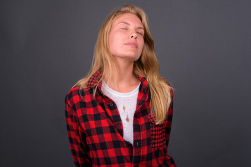 Portrait of young blond hipster woman with eyes closed