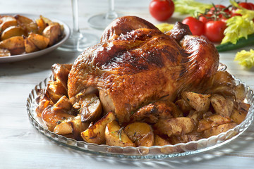 Family dinner. Baked chicken with potatoes