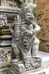Fototapeta na wymiar Stone figure of a protective guardian located at the entrance to Javanese temples. Sonobudoyo at Yogyakarta city, Island of Java 