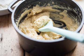 Orange cake batter mixture with spoon 