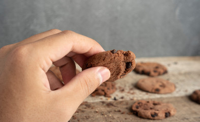 close up human hands take cookies from several available cookies