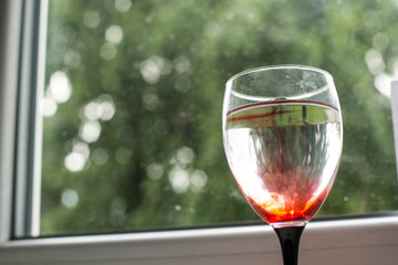 Glass of water on a background of windows...