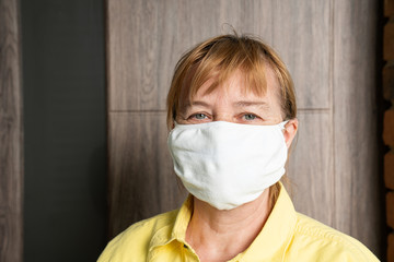 Woman wearing a face mask, looking at camera, close up
