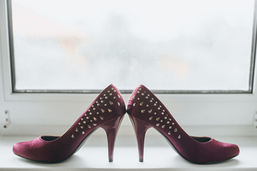 Women's wedding pink, purple shoes with jewelry, high heels stand close-up on the background of a...