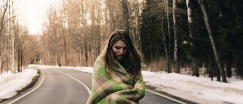 girl in a plaid in the middle of the road
