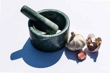 mortar and pestle with garlic bulbs