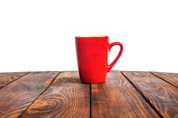  red cup on a wooden background. scarlet mug on the table. goblet on a brown surface