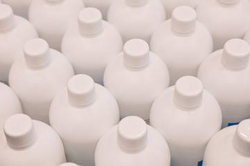 White plastic bottles from under the disinfectant. Concept: wash your hands