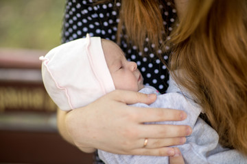 Newborn baby sleeps on mom’s chest. Happiness and intimacy of parental affection