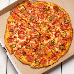 Mexican pizza with jalapeno pepper and bacon on white background