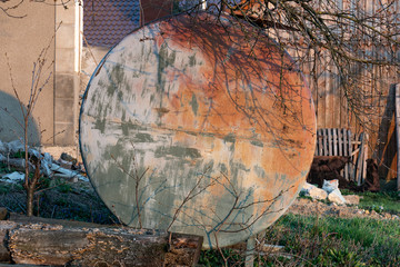 Old round rusty liquid containers. Metal barrels in a distillery.