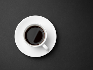 White espresso coffee cup on dish on abstract black background