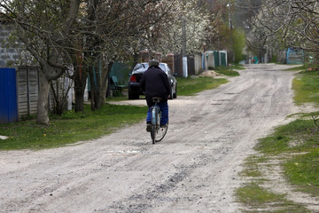 cyclist rides on a rural road