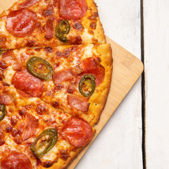 Mexican pizza with jalapeno pepper and bacon on white background