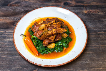 Ribs spinach chips garlic white plate