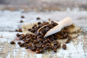 Fototapeta na wymiar Selective focus. Macro. Grains of coffee in a wooden spatula.
