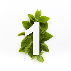 Number one with green leaves. Minimal summer concept. Flat lay.