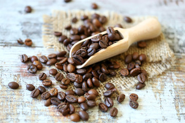 Selective focus. Macro. Grains of coffee in a wooden spatula.