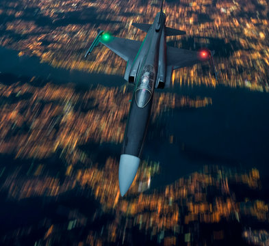 Fighter Jet Aircraft Flying Low Over An Urban Area Of A City In Lights At Night. Army Or Military Bomber Airplane Low Pass Fly By. Aerial Top View